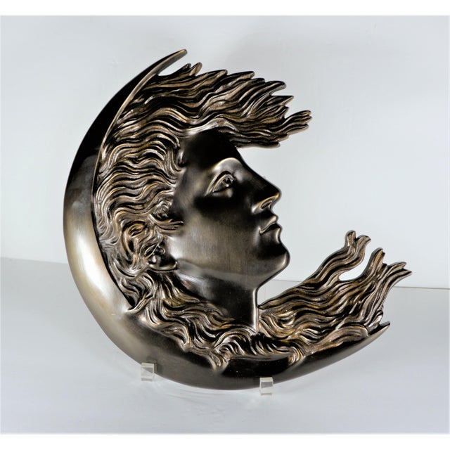 An antique cast bronze plaque of a woman’s face in a half moon/crescent moon. Heavy and highly detailed casting. Plaque is...