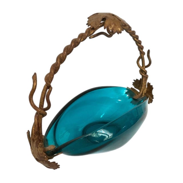 Fabulous vibrant teal blue/green glass bowl in sleek elongated boat shape. The twisted ormalu handle has leaves and vines....