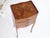 A wooden French side table with beautiful inlaid floral details. The classy tall nightstand has table made out of wood...