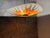 Striking Napako ceiling lamp featuring a bold orange sunburst motif typical of 1970s design. The lacquered glass shade...