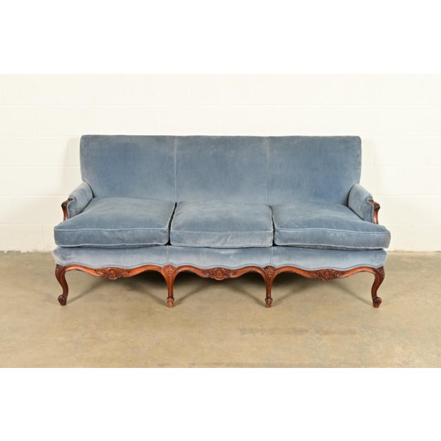 An outstanding French Louis XV style sofa In the manner of Baker Furniture USA, Circa Mid-20th Century Carved walnut...