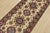 A tribal Caucasian Kazak runner hand-knotted with fine wool on a cotton foundation. This rug features a row of medallions...