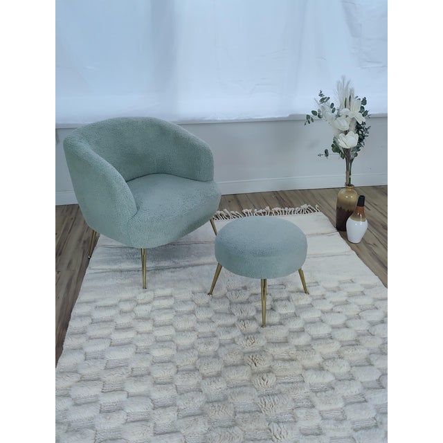 A pale, quietly textured Moroccan rug in undyed ivory wool — a subtle carved checkerboard relief runs across the field,...