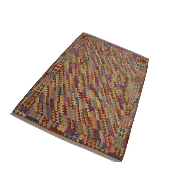 Add a touch of elegance to your home with this casual chic hand woven Tribal Kilim wool rug. Constructed on a loom by...