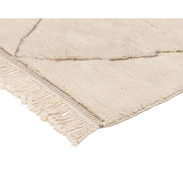 A Berber classic, drawn with a lighter hand: timeless diamonds on a field of warm cream. Fine light taupe lines trace a...