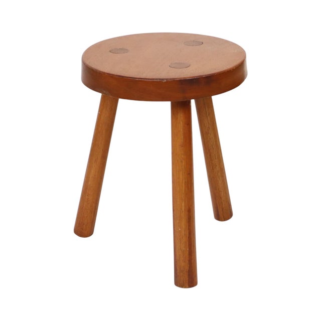 Vintage wooden three-legged stool in a rustic style; the legs are joined using glued mortise-and-tenon joints. It bears...