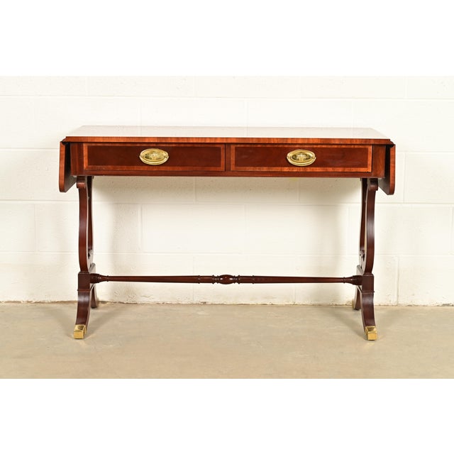 An exceptional English Regency or Georgian style drop leaf writing desk, console table, or sofa table By Baker Furniture...