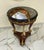 This elegant French-style wood side table features a refined design enhanced with luxurious gold leaf detailing and...