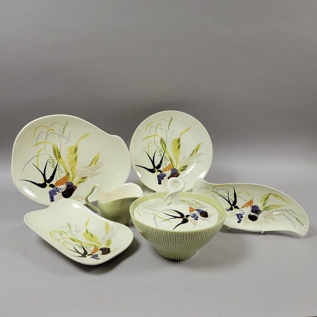 Circa 1950, four dinner plates and 5 serving dishes by Red Wing, Capistrano pattern. The casserole vegetable bowl has a...
