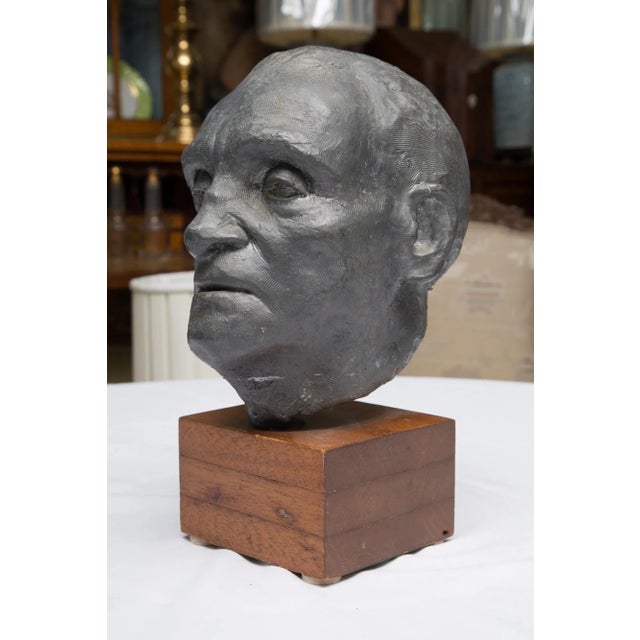 This detailed solid lead sculpture by Charles Watson, 1974, is an impressive bust of a gentleman situated on a walnut...