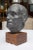 This detailed solid lead sculpture by Charles Watson, 1974, is an impressive bust of a gentleman situated on a walnut...