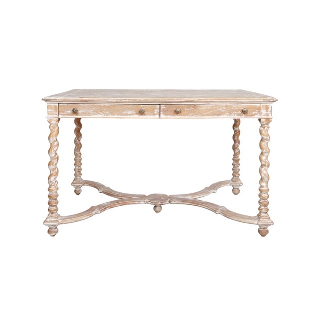 A Gustavian style writing desk by Sarreid, handcrafted with a plank wood tabletop. Two dovetailed frieze drawers in the...