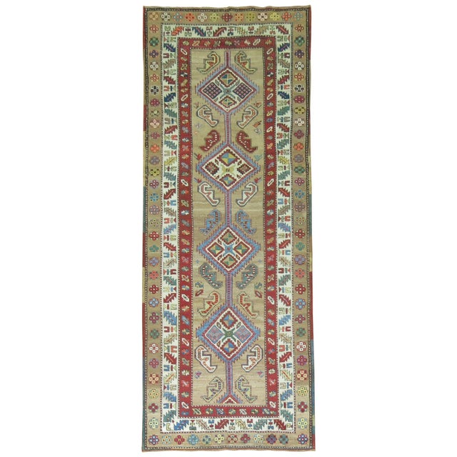 An authentic early 20th century Persian Serab runner with 4 colorful geometric medallions on a camel field and multi-band...