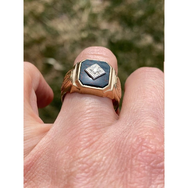 The Port Lincoln: Antique Bloodstone and Diamond Cocktail Ring. The ring centers on an old cut round diamond center in a...