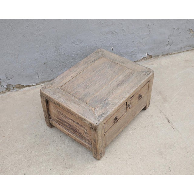 A charming vintage Chinese small cabinet crafted from solid pinewood, dating to the first half of the 20th century. The...