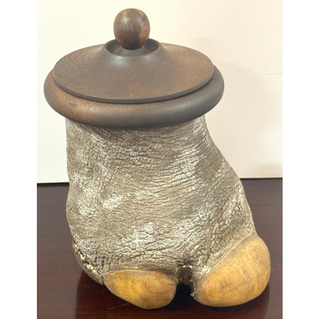 Faux Elephant Foot Humidor with Carved Hardwood Lid, Late 20th Century A highly unusual and sculptural faux elephant foot...