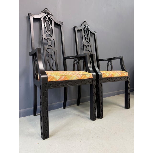 This striking pair of chinoiserie-style armchairs blends timeless elegance with bold visual appeal. Crafted from solid...