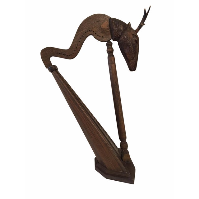 Beautiful antique stringed harp of oak wood. Features an oak body with a carved head depicting a stag / deer. Would make a...