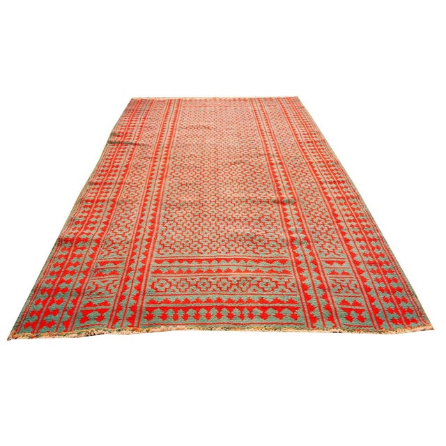 This mid-20th century (circa 1950) Persian formal textile, measuring 5' 4" x 8' 9", features a blue, knotted pile...