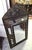 Antique repoussé copper mirror with a carved pediment, showcasing exceptional craftsmanship. The frame is entirely adorned...