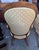 Victorian-style parlor armchair featuring a tall balloon-shaped upholstered back, carved wooden frame, padded arms, and a...