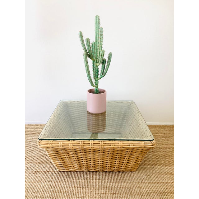 Vintage 1980s Rattan Coffee Table made of a woven rattan / reed material natural honey tone color square in shape clear...