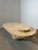 Striking vintage coffee table crafted from solid Mactan stone, featuring a sculptural, asymmetrical silhouette. The design...