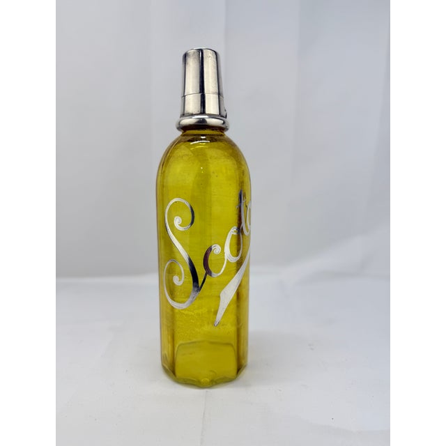 This exceptional antique silver overlay "Scotch" bottle combines functionality with refined craftsmanship, making it a...