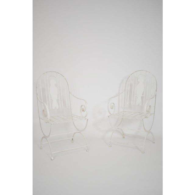 Pair of wrought iron birds armchairs, 1960s. Pair of wrought iron birds chairs with arms making a spiral and the back...