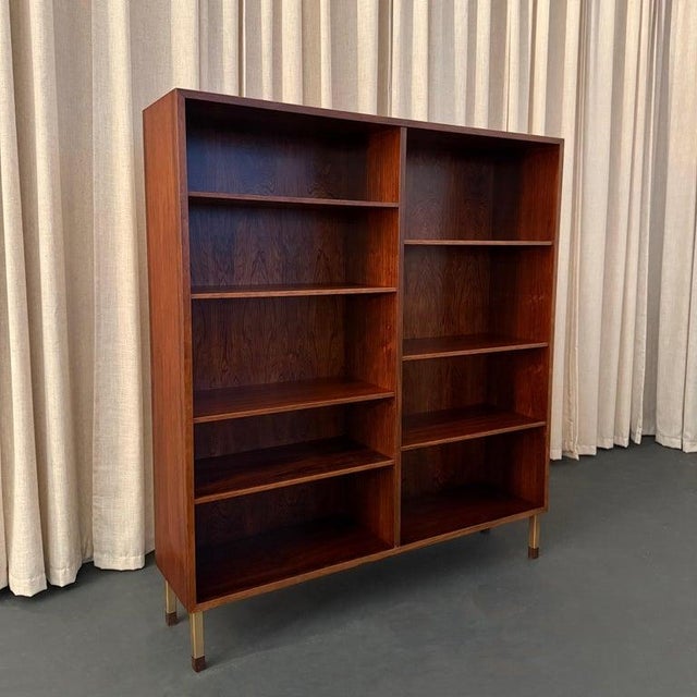 This Scandinavian Modern bookcase display cabinet was designed by Gunni Omann for the family furniture company Omann Jun...