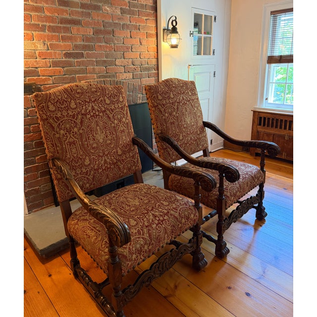 An excellent pair of antique carved wood and fully upholstered Danish Louis XIV style chairs. High back large chairs that...