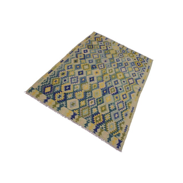 Add a touch of elegance to your home with this casual chic hand woven Tribal Kilim wool rug. Constructed on a loom by...