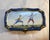 A small French Sevres porcelain hand painted box with hinged lid. The vibrant color with gilt accents depicting 18th...