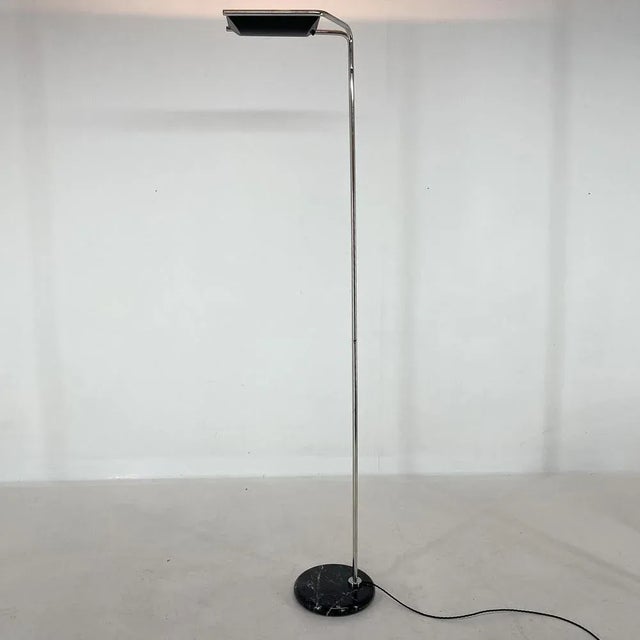 Vintage design floor lamp by Bruno Geschelin for Guzzini, produced in Italy in the 1970's. Made of chrome with marble...