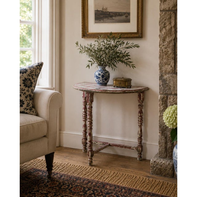 A handsome Federal side table crafted in walnut and painted in an antiqued red and cream. The elegant turned legs create a...