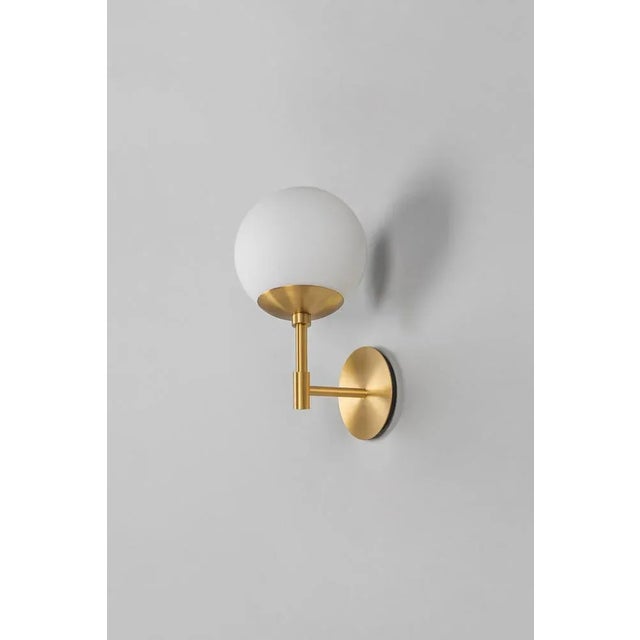 Gold sunset wall sconce by schwung dimensions: w 15 x d 16.1 x h 31 cm materials: brass, frosted glass. All our lamps can...