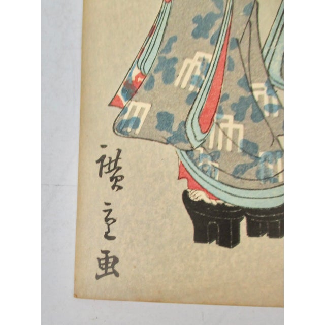 Mid-Century Japanese woodblock print of a traditional scene of three Geisha in the street. Heavily dressed in a...