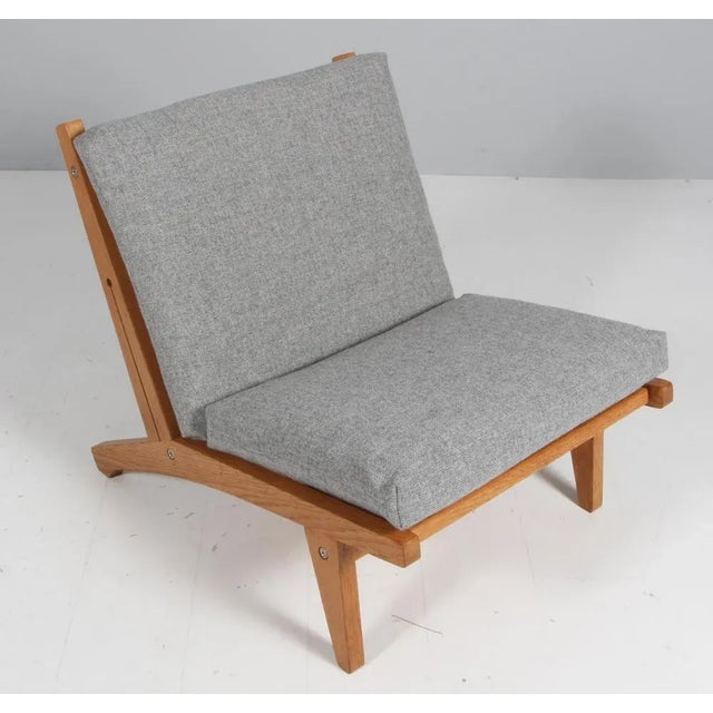 Hans j. Wegner lounge chair with loose cushions new upholstered with grey 130 hallingdal from kvadrat. Frame of solid oak...
