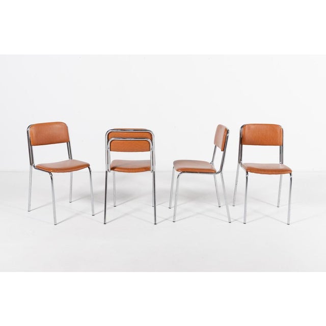 The chairs have a tubular chromed steel frame with the seat and backrest upholstered in brown eco leather. Produced in...