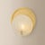 Shanette elevates a simple, rounded sconce form with statement materials. The soft white swirls of the Piastra glass shade...