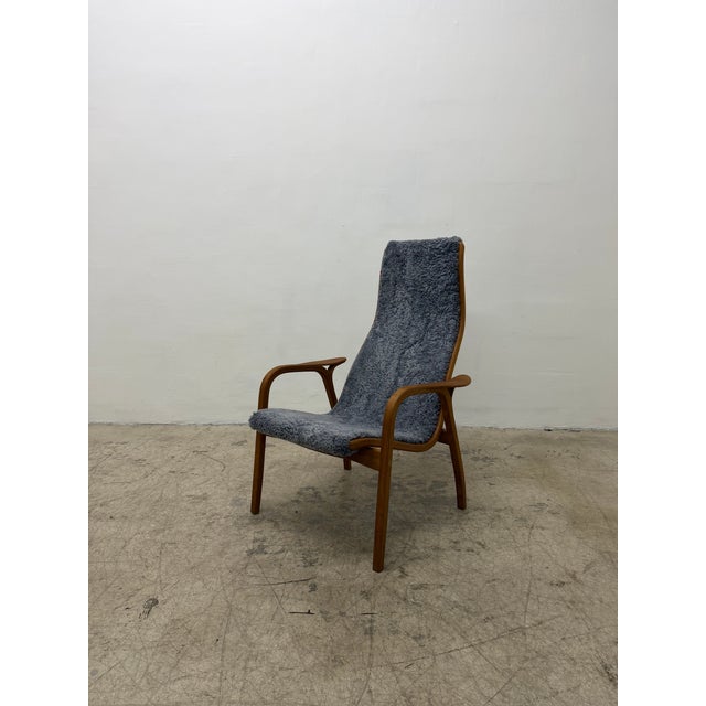 Lamino arm lounge chair with blue-gray sheepskin fabric on a teak wood frame by Yngve Ekström for Swedese, 1990s.