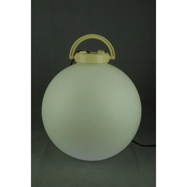 Portable floor lamp designed by Isao Hosoe for Valenti Milano in 1975. This lamp features a white Polyurethane ball with a...