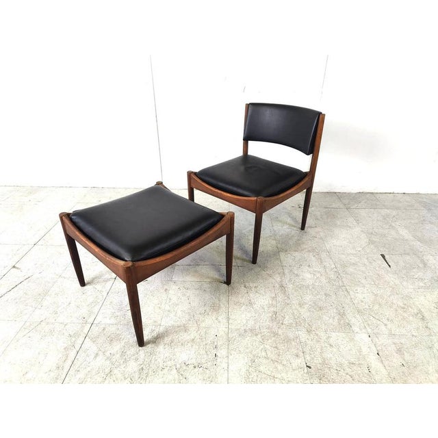Mid century modern leather and wooden lounge chair with stool. Beautiful timeless danish design with black leather...