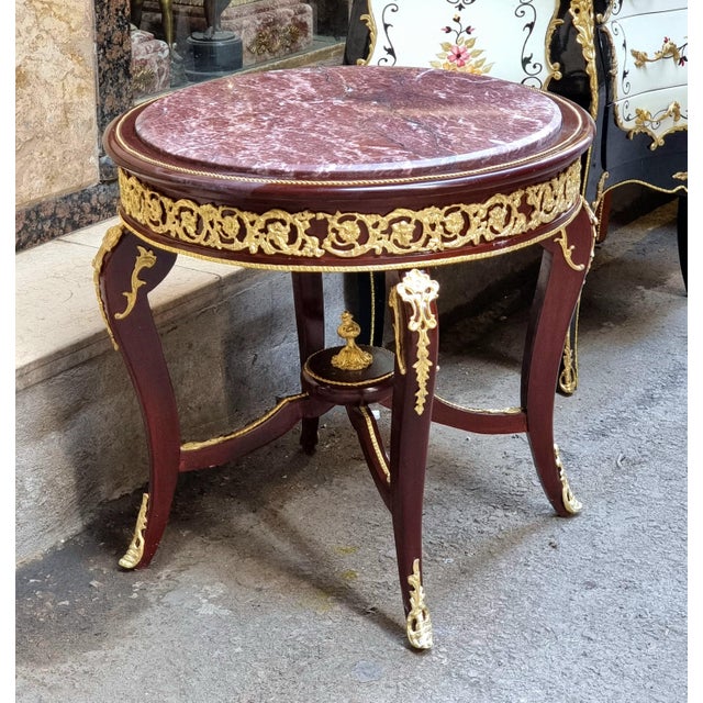 Elevate your space with this elegant Victorian Italian style center table, crafted in solid wood and adorned with refined...