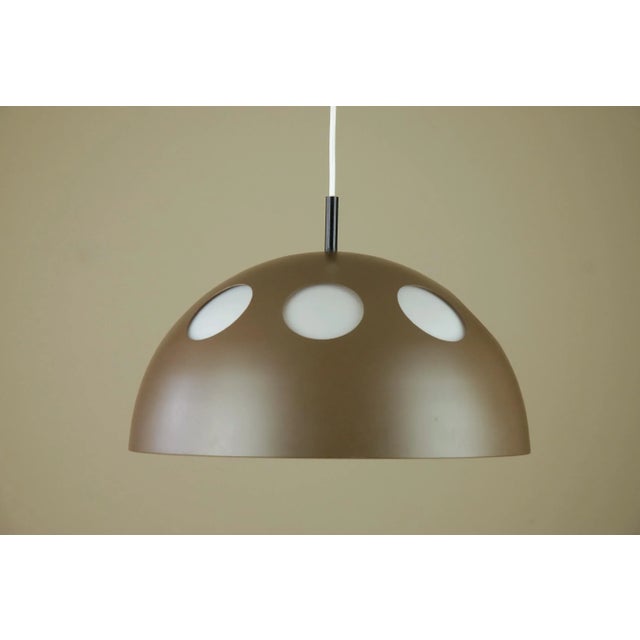 El Duomo pendant designed in 1968 and produced by Raak, Amsterdam. It has a aluminium exterior lacquered chocolate brown...