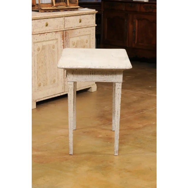 A Danish Louis XVI period painted wood console table from the early 19th century with two drawers, fluted motifs and...