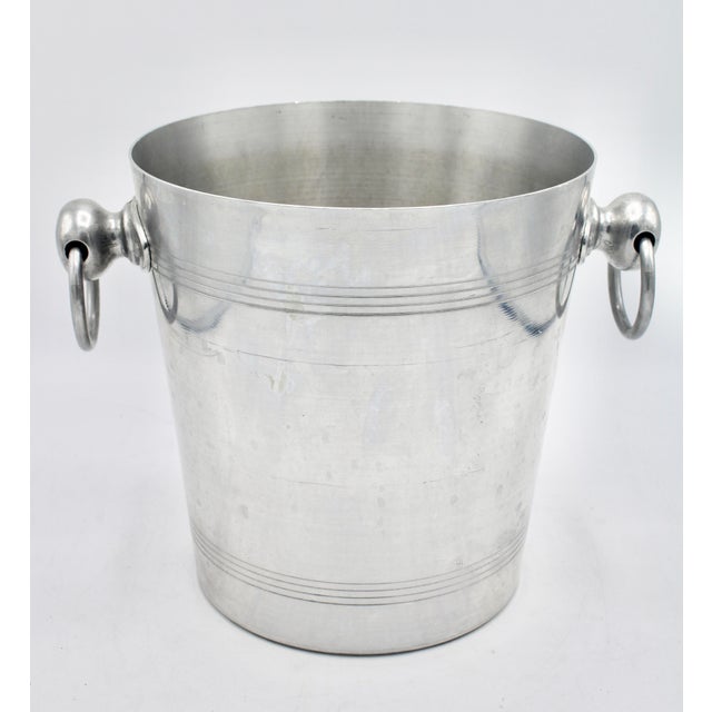 A stunning vintage champagne ice bucket made in France, circa 1960s. This is a bright silver colored ice bucket with...