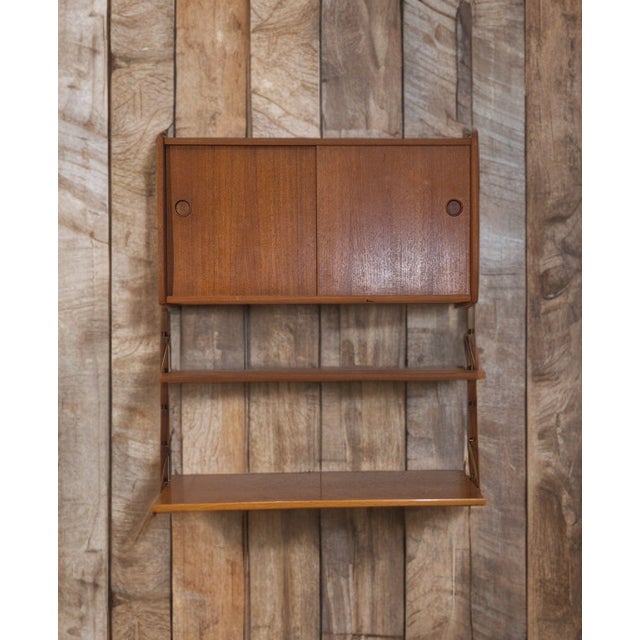 Scandinavian Modular Ergo Wall Shelves in Teak, 1960s, in Very Good conditions. Designed 1960 to 1969 I have official...