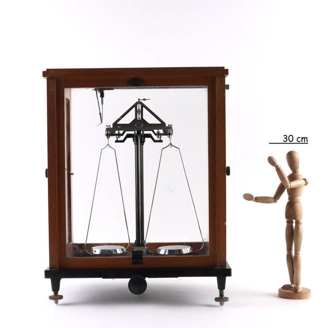 Precision analog scale enclosed in an oak wooden case with sliding front and opening side doors. Metallic manufacturing...
