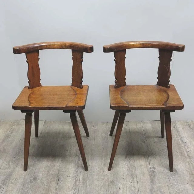 These two chairs were produced around 1900 and have a curved back rest.